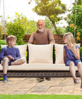 Three Person Wicker Porch Swing With Cup Holder in use, outdoor setting with steel chains and cushions, holds up to 900 lbs