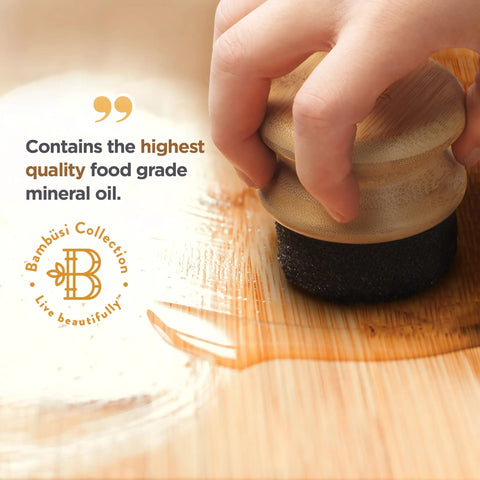 Hand applying Food Grade Mineral Oil For Wood Cutting Boards And Butcher Blocks All In One Food Safe Wood Conditioner on cutting board