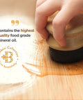 Hand applying Food Grade Mineral Oil For Wood Cutting Boards And Butcher Blocks Your Everyday Kitchen Go To Oil for 12 oz bottle