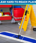 Pro Level Commercial Dust Mop Featuring A Telescopic Stainless Handle And Hella Absorbent Blue Cotton Pad For Quick Floor Sweep And Tight Dust Removal On Hardwood Floors Today on tiled floor with cleaning cart.
