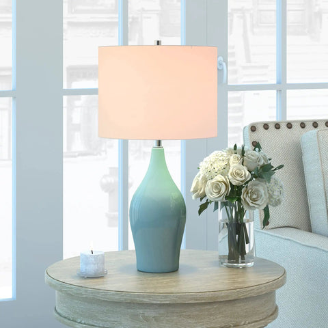 28.25 Inch Tall Porcelain Table Lamp With Teal And Taupe Two Tone Finish, White Linen French Drum Shade, Durable Lining, Modern Living Room Vibe Nightstand Accent Light, Compatible With 60W Incandescent, 9W LED, Or 13W CFL on round wooden table with roses
