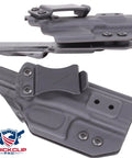 Black Half Inch Chicago Screws With Rubber Washers Kickass Flat Head Through Hole Fasteners For DIY Kydex Leather Holster Knife Sheath Crafting And Belt Clip Projects No Sweat Assembly Top Shelf Gear Up Your EDC Game Today, shown on a tactical holster mounting system.