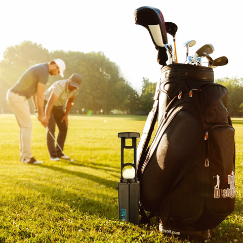 Golf bag with Premium Golf Ball Washer with Variable Hex Brush System on grass, two golfers in background
