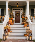 Front porch decorated with pumpkins and sunflowers featuring Lit 10 Inch Outdoor Flameless Candles With Remote And Timer next to lanterns