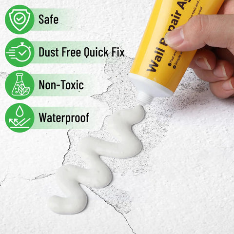 Hand applying spackle from Drywall Repair Kit With Two Tubes Of Spackle 120G Each, Two Scrapers And Two Sanding Pads for wall repair