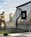 Man practicing golf swing with Golf Target Cloth 5x5 Practice Backstop for Driving Range and Indoor Outdoor Hit Training Aid.
