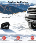 Premium 300W Electric Winch With 12V DC Power And Rugged Steel Body For Heavy Duty Towing And Hoisting Jobs That Need Serious Muscle And Reliable Grip mounted on snowy terrain.