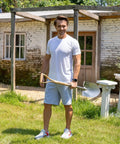 Man holding heavy duty 43 inch round shovel with wooden D handle and stainless steel blade for outdoor yard work.