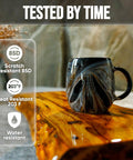 Top Tier Table Top Epoxy Resin Kit For Bars And Counters With Killer UV Resistance And Straight Up Crystal Clear High Gloss Finish For Serious Handmade Creators displayed on a polished wood surface beside a mug.