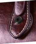 Close-up of Badass Stainless Steel Chicago Binding Screws M6 X 25 Millimeter with secure cap nut on leather