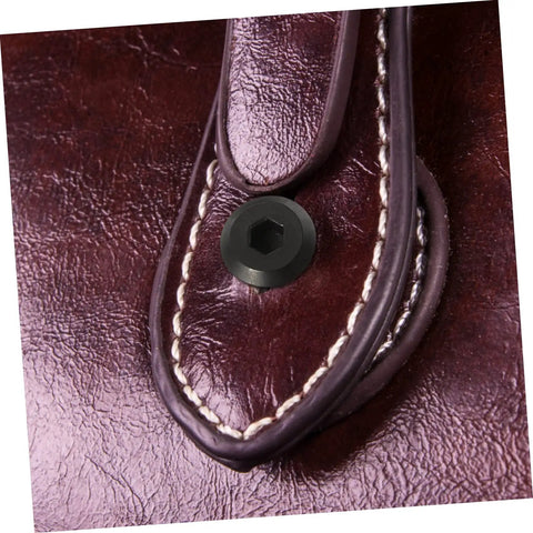 Close-up of Badass Stainless Steel Chicago Binding Screws M6 X 25 Millimeter with secure cap nut on leather