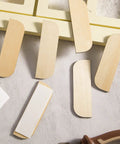 8 Pack Wooden Hinge Repair Plates With Double Sided Tape For Cabinet Doors And Kitchen Cabinets on a textured surface