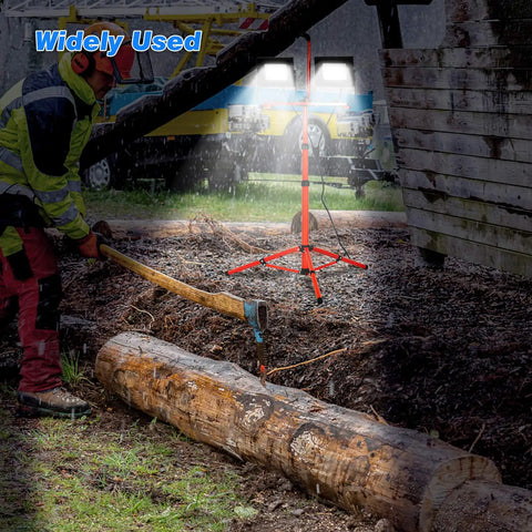 Beast Bright LED Work Light Kit with retractable tripod illuminating outdoor log cutting, dual head 10000 lumen 100W low heat
