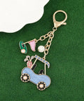 Cute Golf Keychain For Women Sporty Bag Charm Gold Plated Purse Charm shaped like a golf cart with jewels on green background