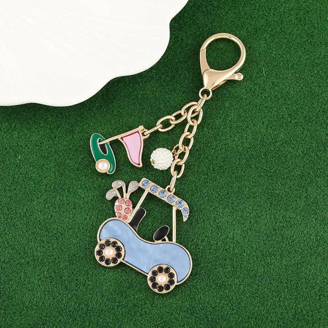 Cute Golf Keychain For Women Sporty Bag Charm Gold Plated Purse Charm shaped like a golf cart with jewels on green background