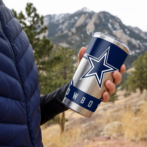Make Every Sip Hit Different With This Dope 20 Oz Stainless Steel Tumbler Featuring Double Wall Insulation And Secure Lid For Dallas Cowboys Fans Who Want Their Coffee Tea Or Cocktails Staying Frosty All Day Long in hand outdoors.