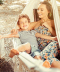 Mother and child relaxing in Boho Macrame Hammock With Elegant Tassels For Patio And Yard Cozy And Chill For Indoor Or Outdoor Use 450 Pound Capacity Includes Tie Ropes And Drawstring Bag Dark Grey