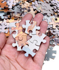 Hand holding pieces of Blank Sublimation Jigsaw Puzzle Set 45 Pieces 8 By 11 Inches Heat Press Ready For DIY Projects Weddings Decor.