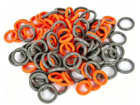 Pile of orange and grey O-rings from the Orange And Grey Quick Disconnect O Ring Set For One Quarter And Three Eighths Inch Pressure Washer Couplers 50 Pack Twenty Five Plus Twenty Five High Temperature O Rings For Up To Two Hundred Twelve Degrees Fahrenheit.