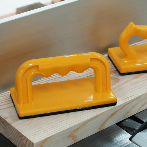 Heavy Duty Push Block And Push Stick Set For Table Saws Router Tables Band Saws on a work surface, featuring yellow safety grips.