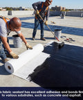 Two workers applying High Density Stitched Polyester Roof Mesh Fabric 40 X 157.5 Ft Crack Resistant Tape on a roof for sealing.