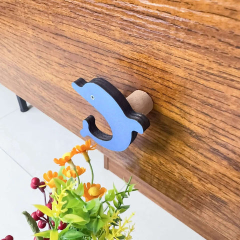 Blue dolphin shape from 8 Pack Ocean Sea Animal Wooden Cabinet Knobs Set With Tiny Turtle Decor For Nursery And Kids Rooms.