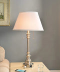 Spyglass Table Lamp With Dual Outlets In Brushed Steel Finish on a table, classic style, 30.5 inches tall, living room view