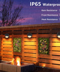 12 Pack Low Voltage Deck Lights 5W LED Landscape Step Lights With Fastlock2 providing warm accent on wooden fence in rain