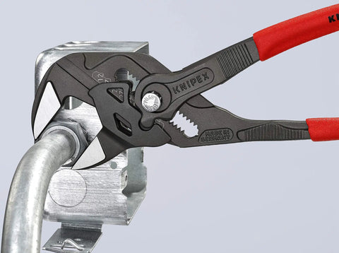 Heavy Duty 10 Inch Pliers Wrench With Adjustable Smooth Jaws grips a metallic pipe fitting in a workshop setting.