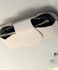 Premium Leather Sunglasses Holder For Car Visor With Secure Clip Stays Put And Protects Sunnies From Scratches Universal Fit For Cars SUVs Trucks Sleek Beige on visor with sunglasses inside.