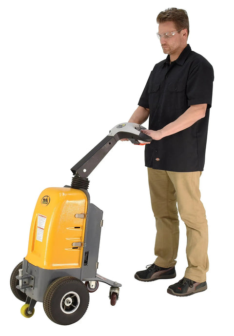 Person operating Heavy Duty Electric Powered Tugger With 1000 Lb Pull Capacity For Effortless Factory Material Handling in bright yellow.
