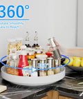 Hella Rugged 13 Inch Metal Lazy Susan Turntable For Kitchen Cabinet And Pantry Rack Storage White filled with spice jars on countertop.