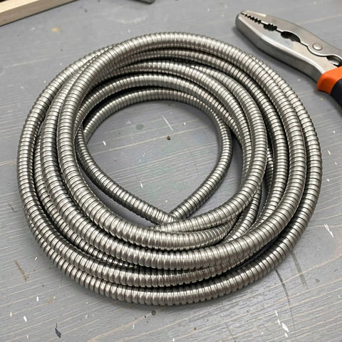 Top Notch Flexible Stainless Steel Wire Loom Sleeve For Heavy Duty Cable Management, 5mm ID, silver, coiled for wiring projects.