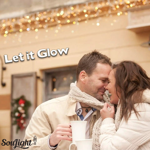 Couple close together with mugs, under string lights, text 'Let it Glow', promoting 7 Watt Night Light Replacement Bulbs 12 Pack.