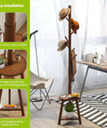 Freestanding Bamboo Coat Rack With Two Shelves And Eight Hooks, Easy Assembly, 12.6 Inch Storage Tray in an office setting.