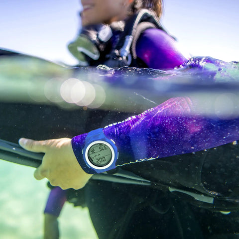 Diver wearing i200C Wrist Dive Computer With Bluetooth, DiverLog App Access, and Phone Sync, blue finish, underwater monitoring