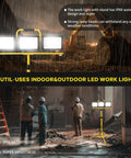 Heavy Duty Led Work Light With Beefy Telescoping Tripod, 30000 Lumens, Three Pivotable Heads, Waterproof Housing, And Badass 16 Ft Power Cable For Projects in use on a construction site.