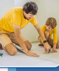 Father and son using Top Shelf White Foam Insulation Roll With Super Reflective Radiant Barrier Coating for home project.
