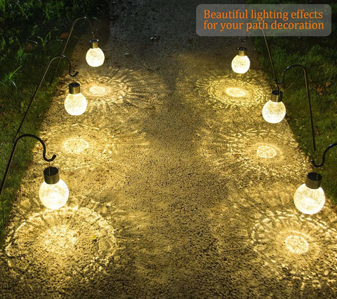 4 Pack Solar Lanterns With Shepherd Hooks No Wiring Easy Setup Outdoor Color Changing Crackle Glass 3 Lumens Waterproof Garden Lights illuminating a path at night