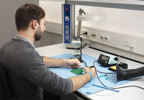 Technician using Blue ESD Soldering Mat 900 X 600 MM, Heavy Duty And Pro Grade, Heat, Solder, Chemical And Oil Resistant on desk
