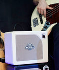 Musician with acoustic guitar and bass using 15W Practice Guitar Amp With 9 Digital Amp Models, 6.5 Inch Speaker, Bluetooth.