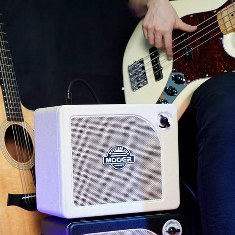 Musician with acoustic guitar and bass using 15W Practice Guitar Amp With 9 Digital Amp Models, 6.5 Inch Speaker, Bluetooth.