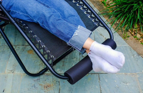 Two Pack Zero Gravity Chair Foot Rest Cushions For Outdoor Recliners in use, showing footpads attached to chair for comfort, black