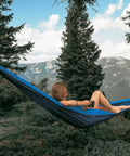 Person relaxing in Double Travel Hammock Ultralight Parachute Nylon With Breathable Fabric Packable Carry Bag Two Tree Straps And Aluminum Carabiners