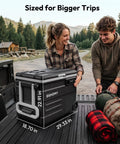 Smart 12V Car Fridge 59 Quarts With App Control And LCD Panel displayed by a woman and man outdoors, showing its size and features.