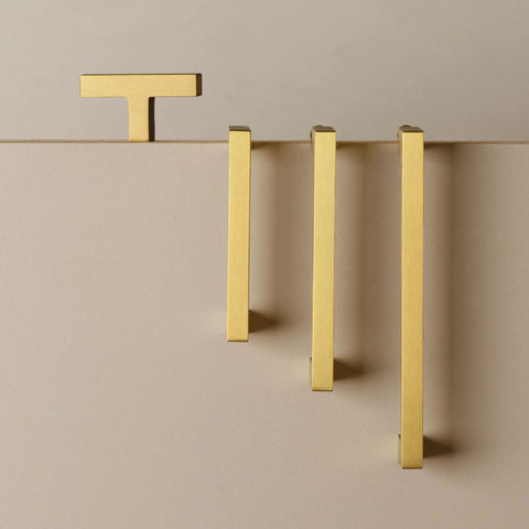 5 Pack Solid Brass Cabinet Pulls With Six And A Quarter Inch Hole Centers In Brushed Matte Gold displayed on beige surface