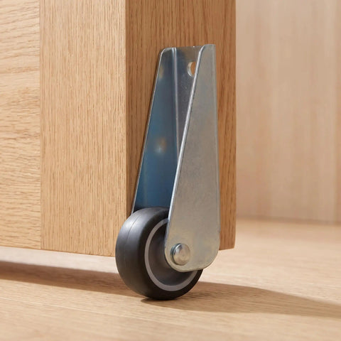 Close-up of 5pcs Wooden Gate Wheel Side Mount Caster with 1.5 Inch Rubber Rollers attached to wooden furniture.