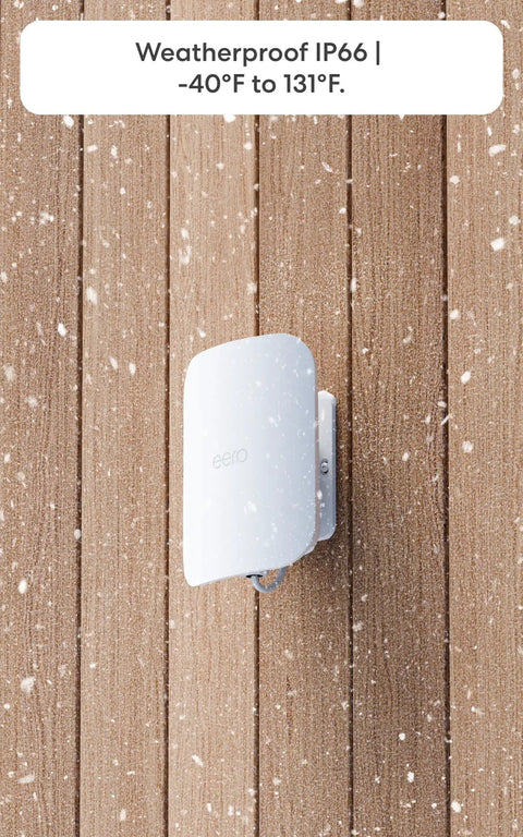 Outdoor 7 Dual Band Mesh WiFi Router With IP66 Weatherproof mounted on wall covered in snowflakes.