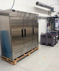 Rock Solid 82 Inch Wide Commercial Reach In Freezer With Three Doors And 72 Cubic Feet Capacity Stainless Steel in a kitchen setup.