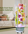 All In One Vertical Hydroponic Garden Tower With LED Grow Lights, Eight Levels, Thirty-Two Large Pods, Eight Gallon Indoor Growing System For Veggies, Herbs And Tomatoes, Pump And Dual Timer Included in a living room setting.
